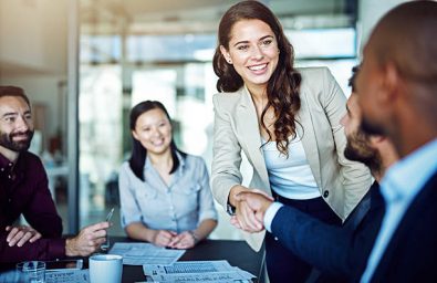 Cropped shot of two businesspeople shaking hands during a meeting in the boardroom